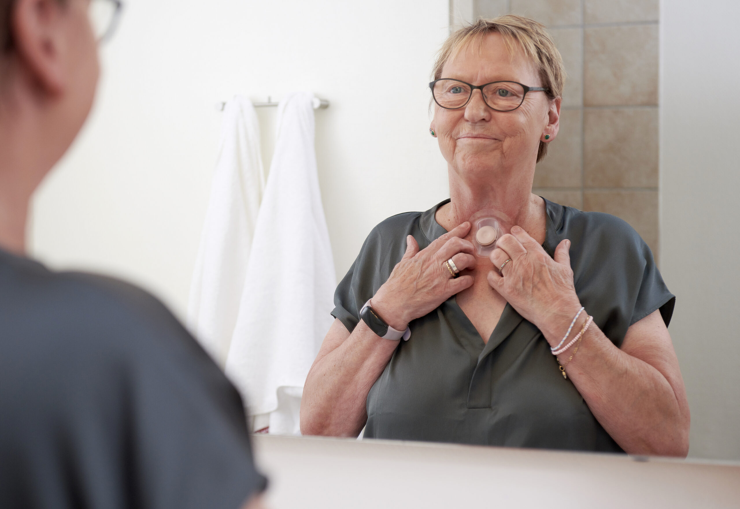 woman taking care of her stoma in bathroom